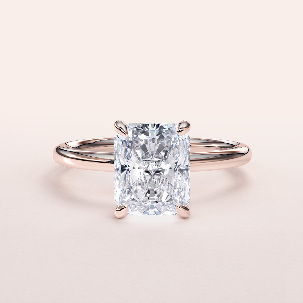 Elegant 14K rose gold engagement ring featuring a radiant-cut diamond in a stunning solitaire design, perfect for special occasions.
|
#14KRecycledRoseGold
#18KRecycledRoseGold