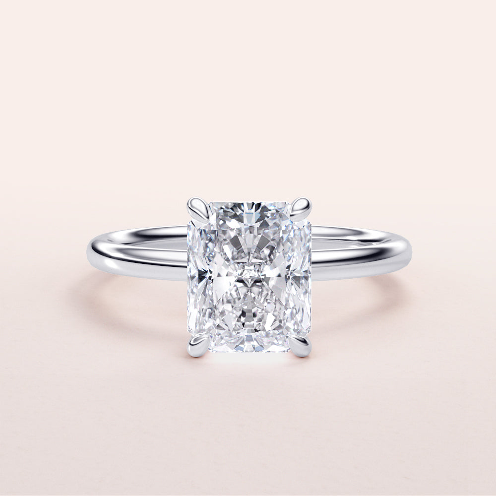 Elegant 14K/18K white gold engagement ring featuring a radiant-cut diamond in a classic solitaire setting.|
#14KRecycledWhiteGold
#18KRecycledWhiteGold
#Platinum