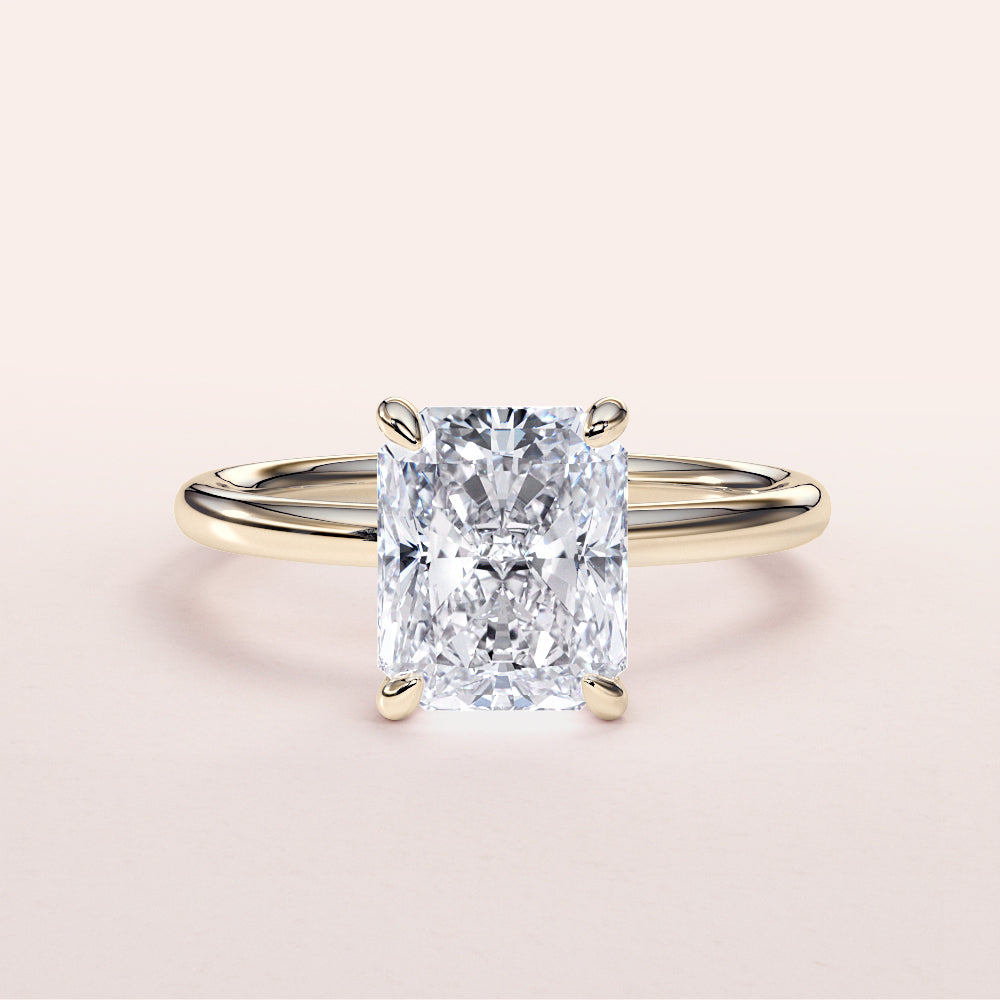 14K Yellow Gold Radiant Cut Diamond Engagement Ring, a stunning classic solitaire design perfect for unforgettable moments.|
#14KRecycledYellowGold
#18KRecycledYellowGold