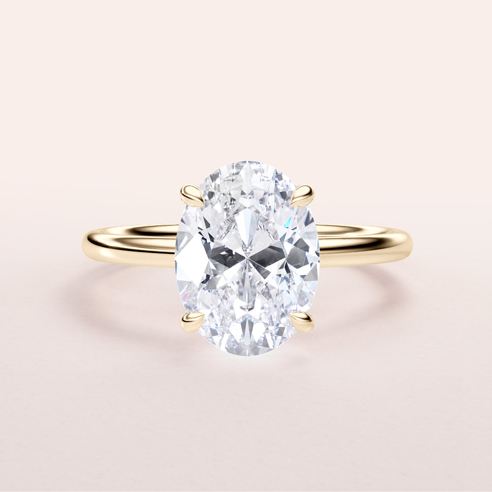 14K yellow gold engagement ring featuring a stunning oval-cut diamond center stone. Elegant and timeless design for proposals.|
#14KRecycledYellowGold
#18KRecycledYellowGold