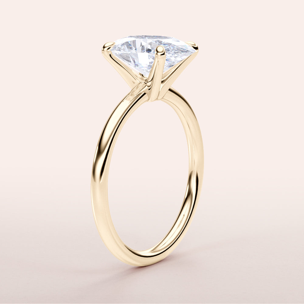 Elegant 14K or 18K gold solitaire engagement ring featuring a radiant cushion-shaped diamond in a classic prong setting.|
#14KRecycledYellowGold
#18KRecycledYellowGold