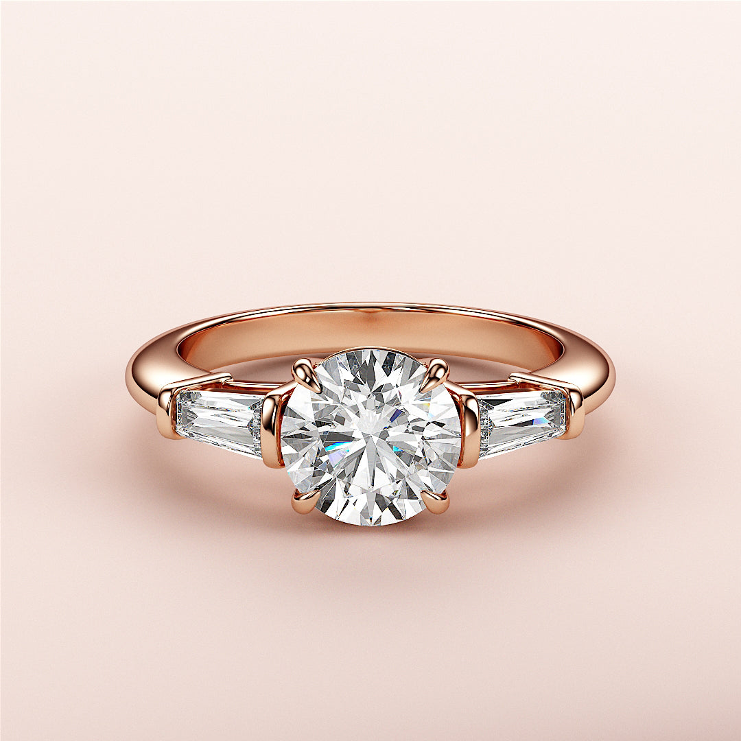 Elegant 14K rose gold engagement ring featuring a round diamond and tapered baguette accents. Perfect for special occasions.|
#14KRecycledRoseGold
#18KRecycledRoseGold