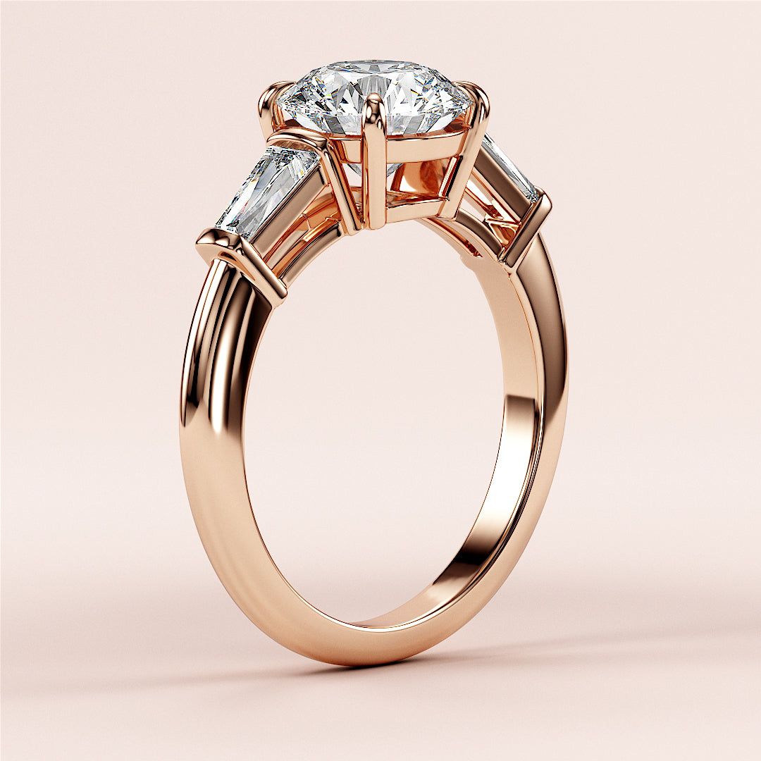 Elegant 14K/18K rose gold engagement ring with oval diamond center and tapered baguette side stones, perfect for your special moment.|
#14KRecycledRoseGold
#18KRecycledRoseGold