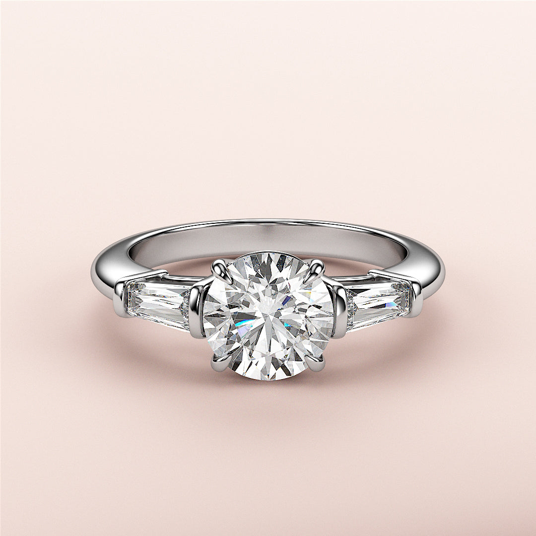 Elegant round diamond engagement ring with tapered baguette side stones in 14K/18K gold or platinum band.|
#14KRecycledWhiteGold
#18KRecycledWhiteGold
#Platinum