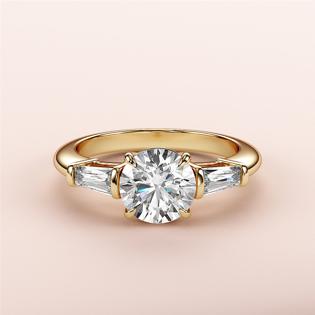 Elegant yellow gold engagement ring with round-cut diamond and tapered baguette accents, available in 14K, 18K, or platinum.|
#14KRecycledYellowGold
#18KRecycledYellowGold