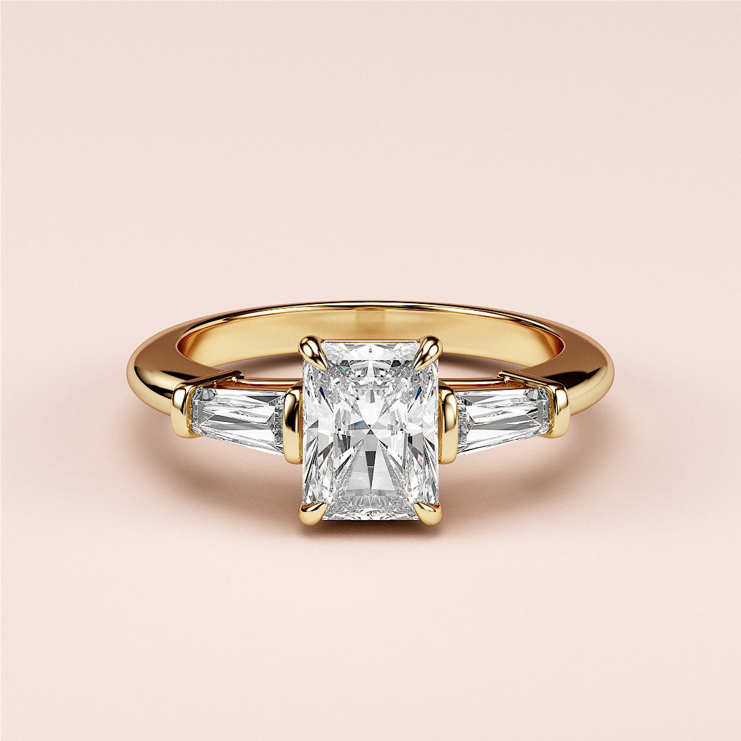 Radiant cut diamond engagement ring with tapered baguette side stones in yellow gold, available in 14K, 18K, and platinum.|
#14KRecycledYellowGold
#18KRecycledYellowGold
