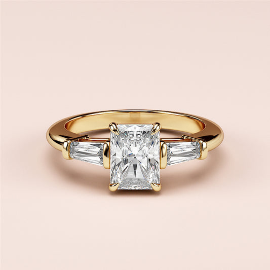 Radiant cut diamond engagement ring with tapered baguette side stones in yellow gold, available in 14K, 18K, and platinum.