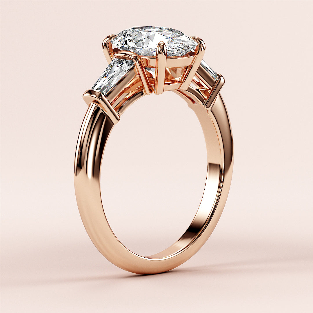 Elegant rose gold engagement ring with marquise-cut diamond and tapered baguette accents, available in 14K and 18K gold or platinum.|
#14KRecycledRoseGold
#18KRecycledRoseGold