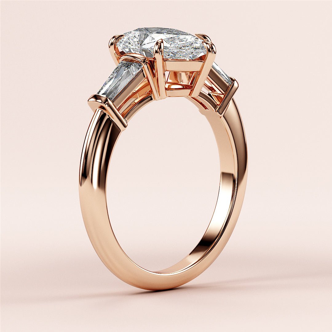 Elegant rose gold engagement ring with oval-cut diamond and baguette accents, available in 14K, 18K, or platinum.|
#14KRecycledRoseGold
#18KRecycledRoseGold