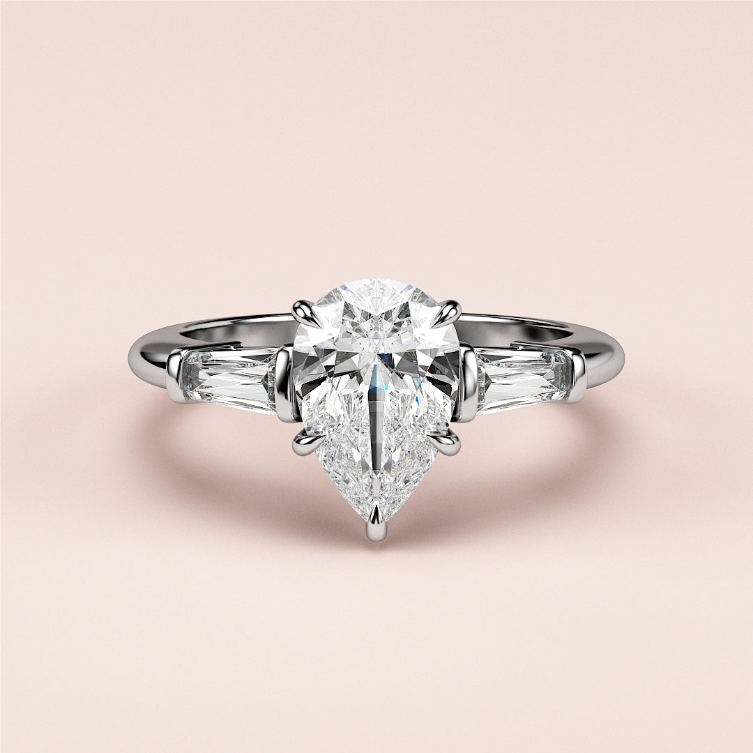 Elegant 14K or 18K white gold engagement ring with pear-shaped diamond center and tapered baguette diamonds.|
#14KRecycledWhiteGold
#18KRecycledWhiteGold
#Platinum