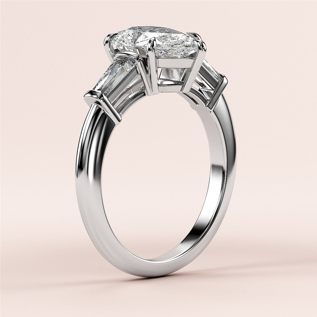 14K White Gold Butterfly Engagement Ring with Pear-Shaped Diamond and Trapezoid Cut Side Stones on Beige Background.|
#14KRecycledWhiteGold
#18KRecycledWhiteGold
#Platinum