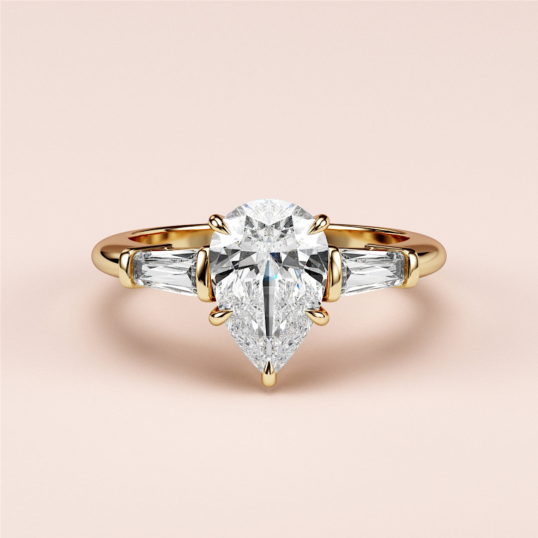 "Luxurious yellow gold pear-shaped diamond engagement ring with baguette side stones in a 14K or 18K setting."|
#14KRecycledYellowGold
#18KRecycledYellowGold