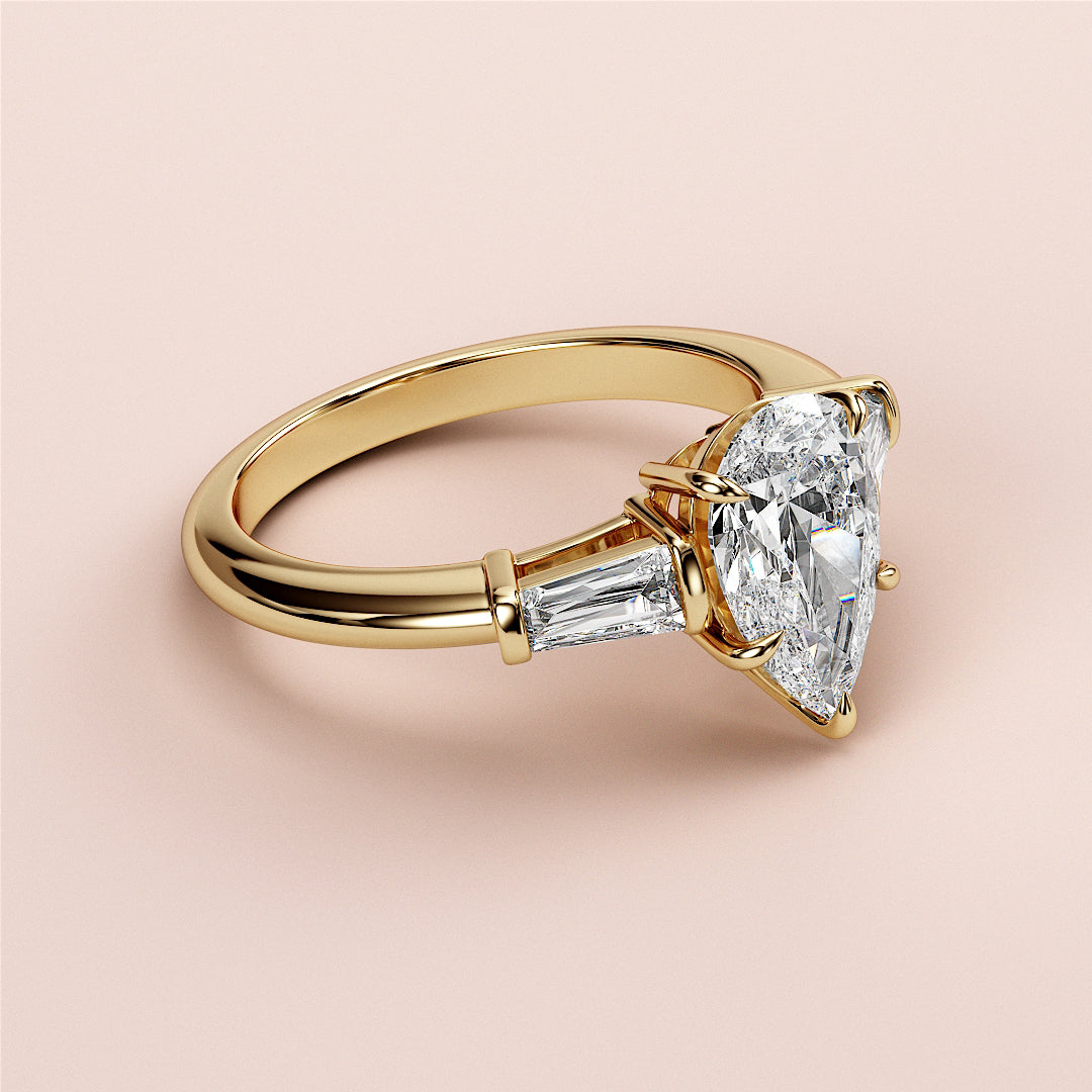 Elegant 14K gold engagement ring featuring a butterfly design, three-stone setting with tapered baguette diamonds.|
#14KRecycledYellowGold
#18KRecycledYellowGold