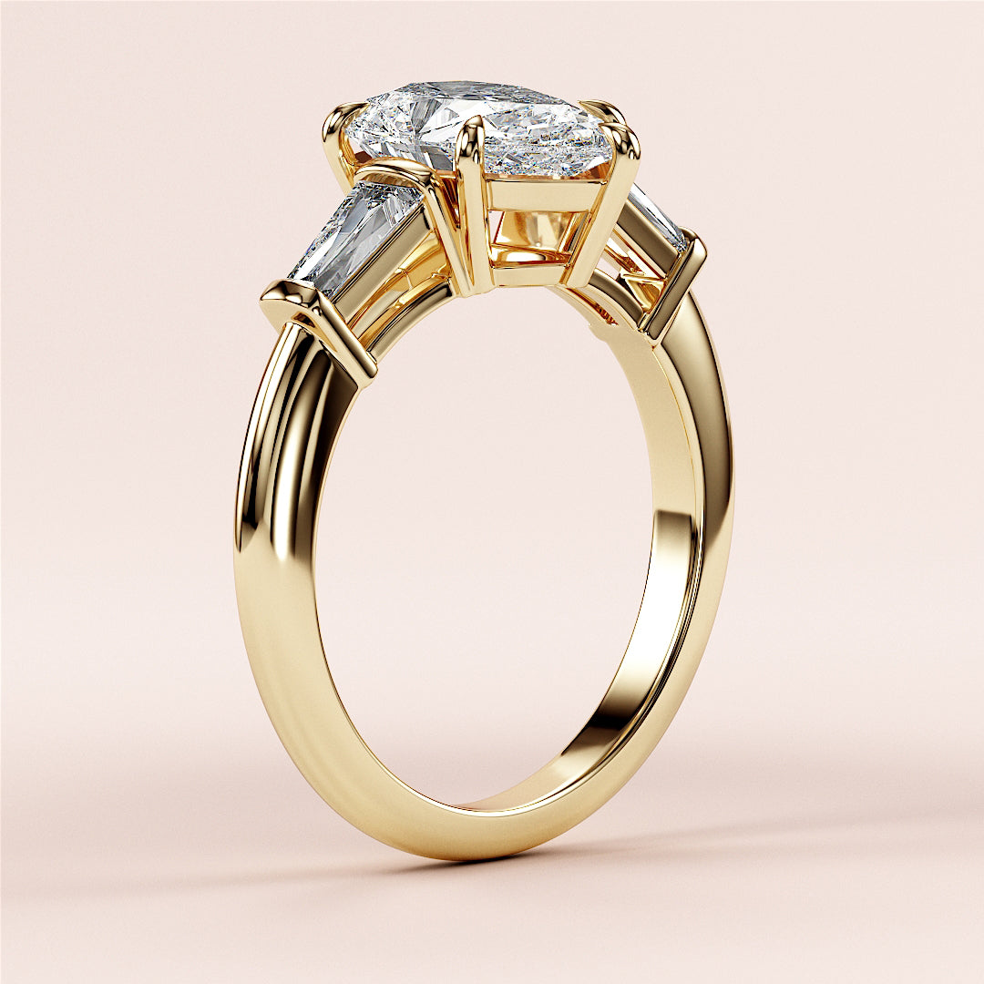 Elegant 14K yellow gold butterfly engagement ring with a pear-shaped diamond and tapered baguettes, showcasing exceptional craftsmanship.|
#14KRecycledYellowGold
#18KRecycledYellowGold