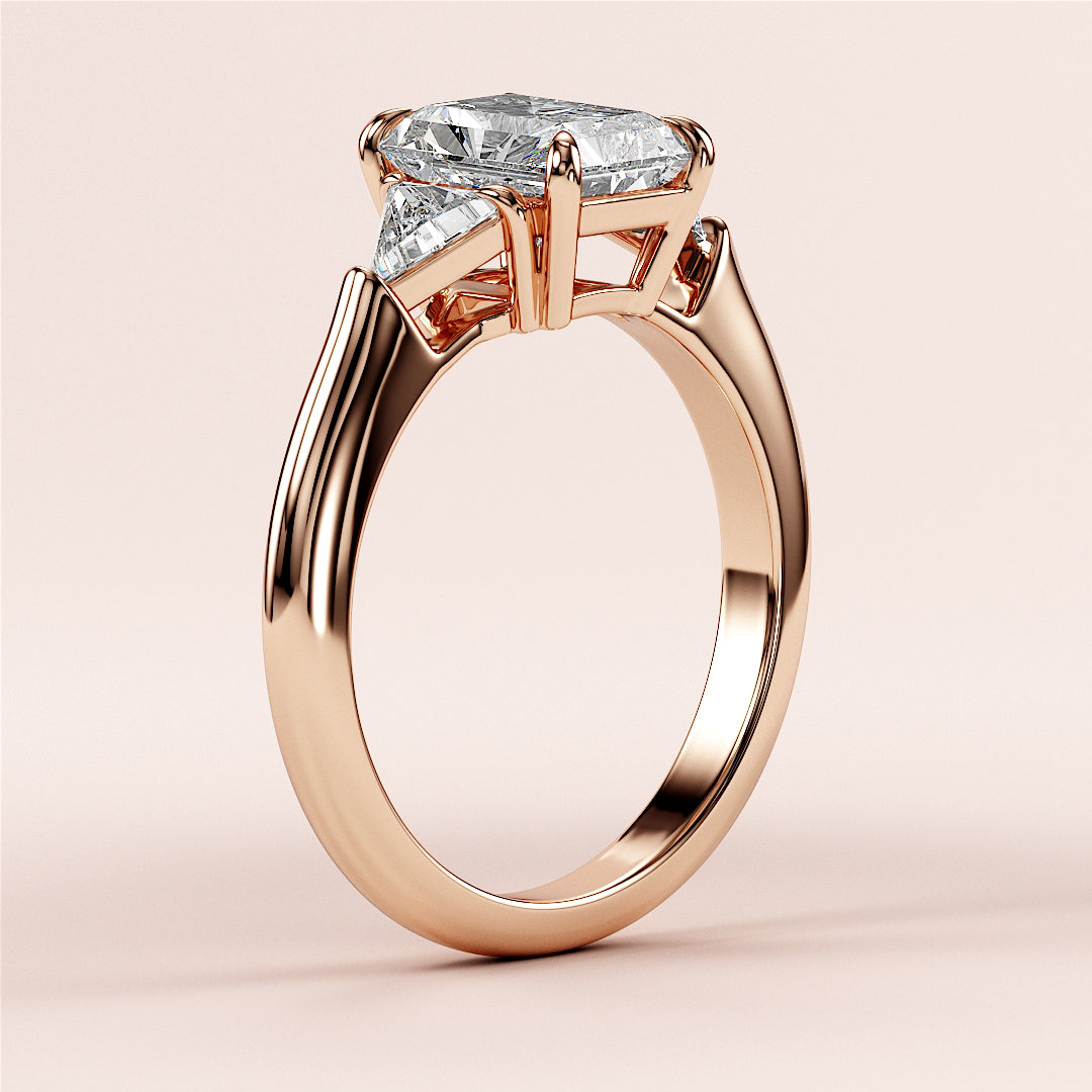 Rose Gold 14K radiant three-stone triangle engagement ring with elongated diamond shape setting, perfect for a timeless proposal.|
#14KRecycledRoseGold
#18KRecycledRoseGold