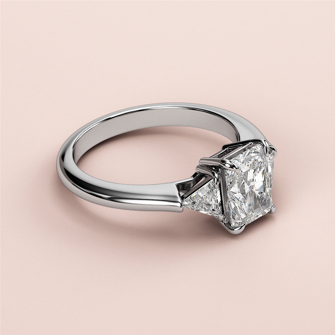 Radiant-cut diamond engagement ring in 14K, 18K, or platinum with accent diamonds, featuring a stunning three-stone triangle design.|
#14KRecycledWhiteGold
#18KRecycledWhiteGold
#Platinum