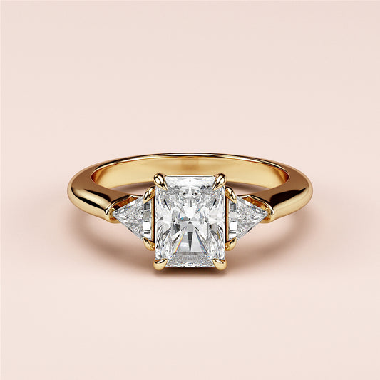 Elegant 14K yellow gold engagement ring featuring a radiant-cut diamond center stone and two trillion-cut side diamonds.