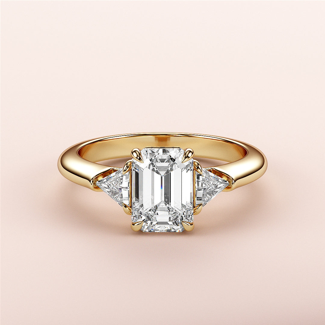 Emerald-cut diamond ring with side trillion diamonds in 14K yellow gold, a stunning engagement ring for timeless elegance.|
#14KRecycledYellowGold
#18KRecycledYellowGold