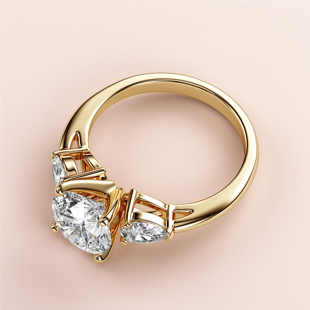 Elegant 14K yellow gold engagement ring with round-cut diamond centerpiece and pear-shaped diamonds, perfect for style and sophistication.|
#14KRecycledYellowGold
#18KRecycledYellowGold