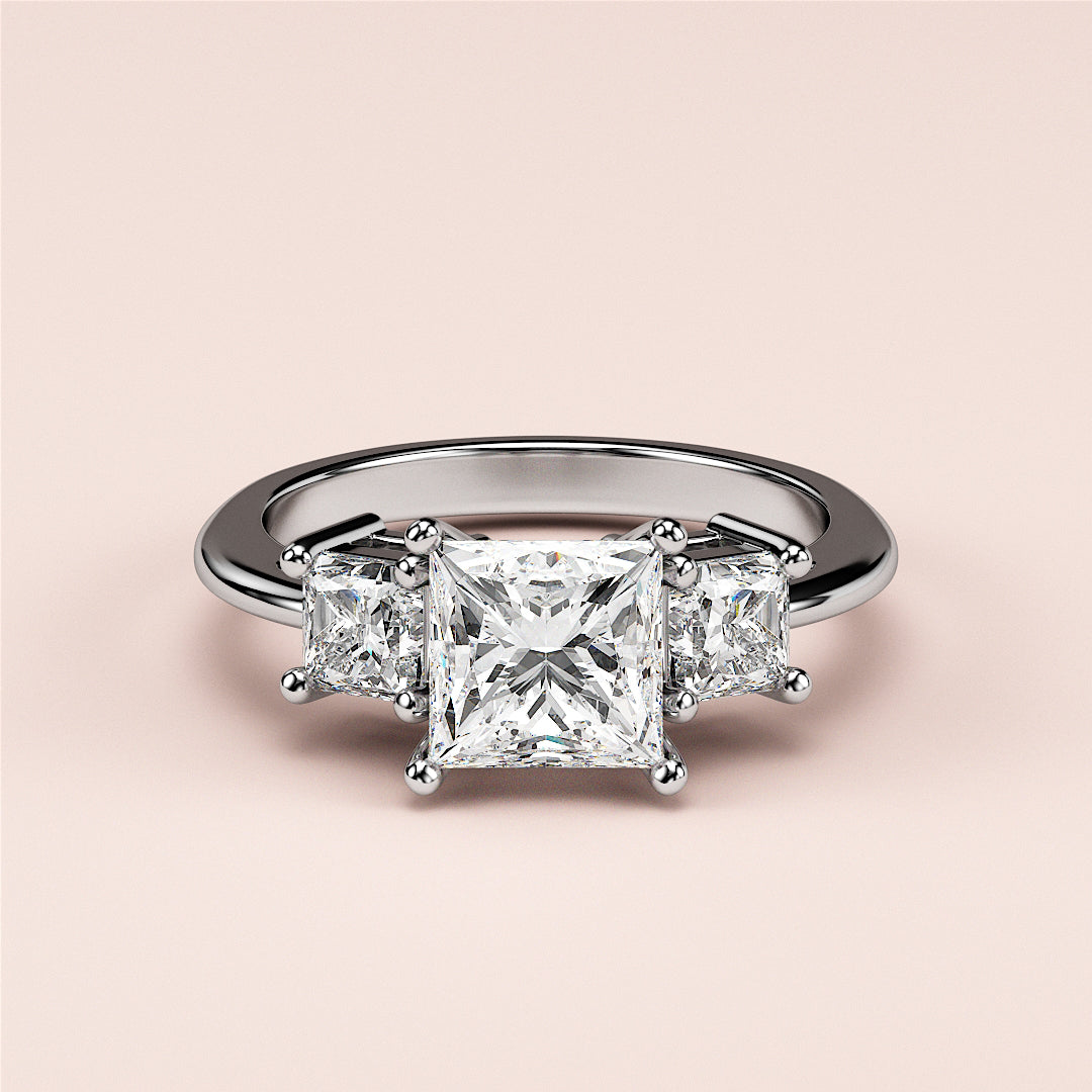 Elegant 14K or 18K gold three-stone engagement ring with a princess-cut center diamond and two side diamonds.|
#14KRecycledWhiteGold
#18KRecycledWhiteGold
#Platinum