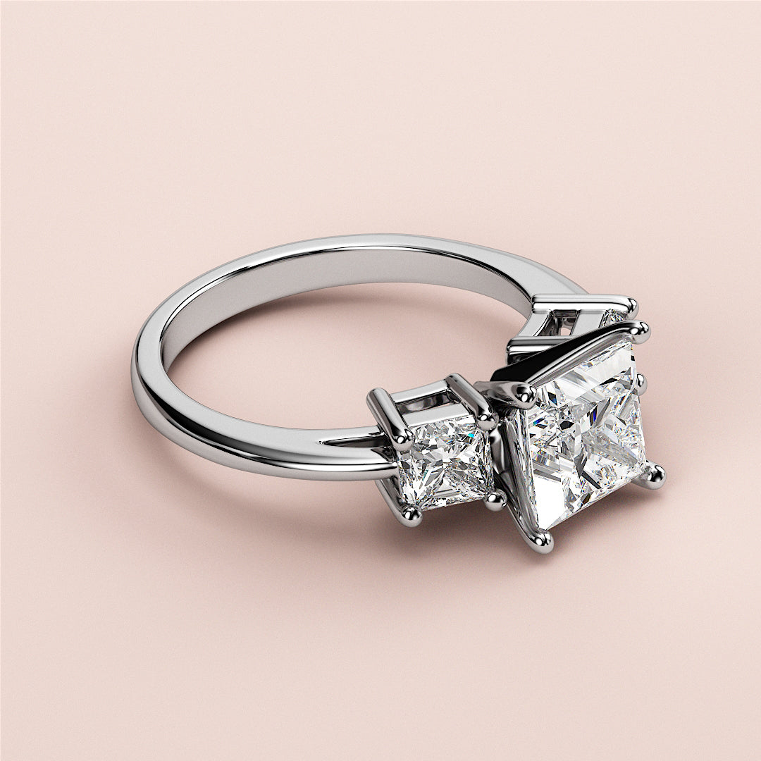 Elegant 14K/18K white gold engagement ring featuring princess-cut and square-cut diamonds in a stunning three-stone design.|
#14KRecycledWhiteGold
#18KRecycledWhiteGold
#Platinum