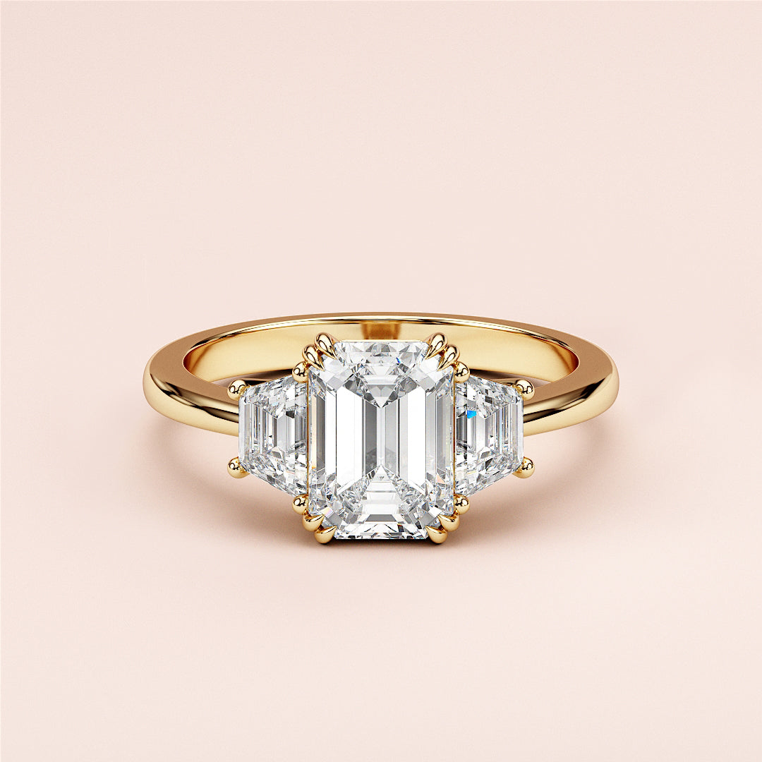 Stunning 14K or 18K gold and platinum engagement ring with emerald-cut diamond and trapezoid side stones.|
#14KRecycledYellowGold
#18KRecycledYellowGold