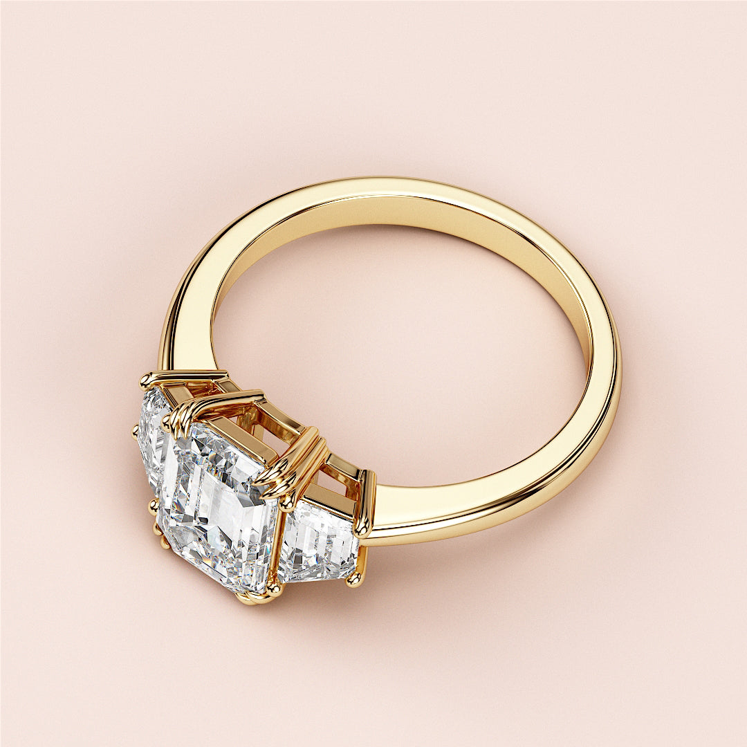 Elegant emerald-cut diamond ring in 14K or 18K gold, featuring a stunning three-stone design for a timeless look.|
#14KRecycledYellowGold
#18KRecycledYellowGold