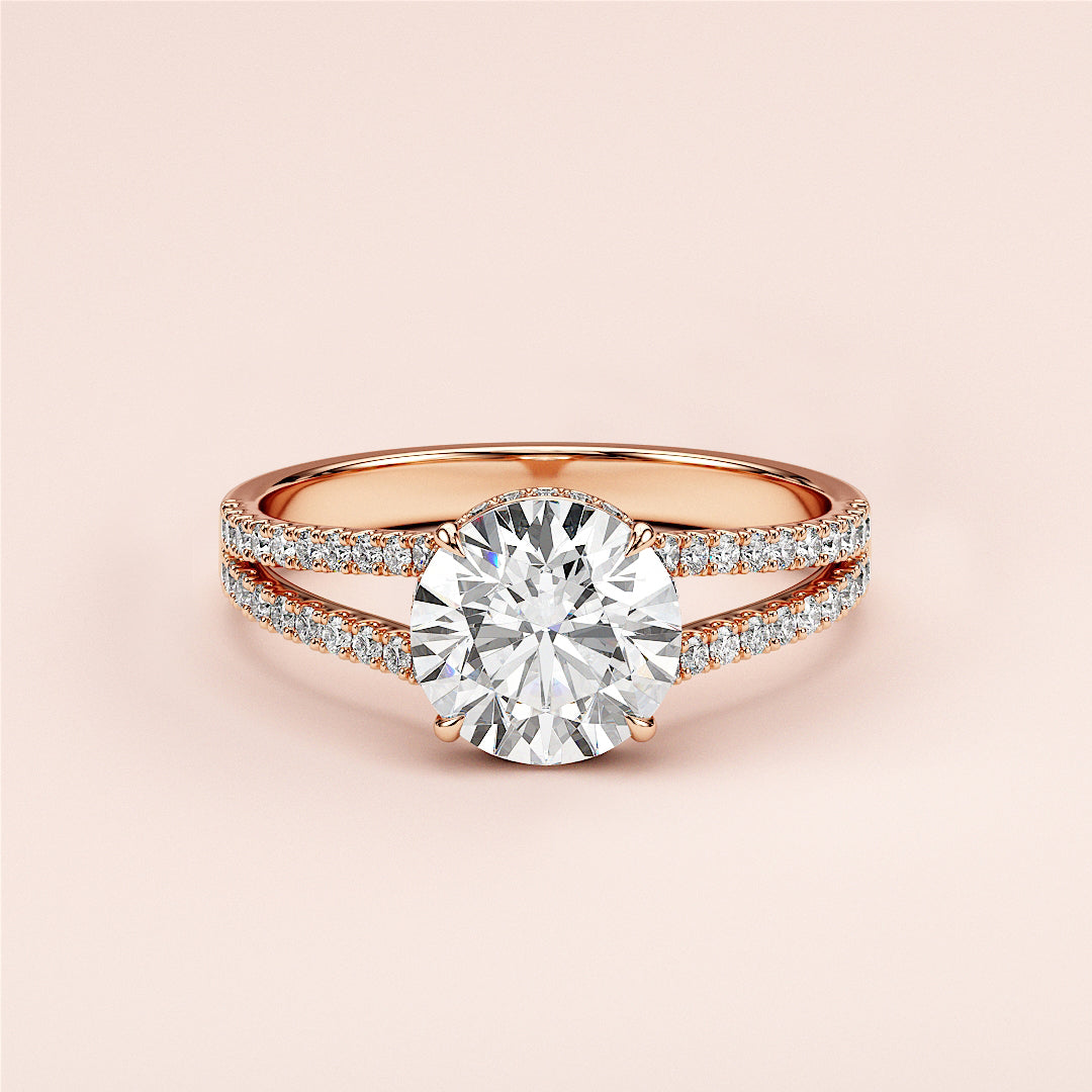 Elegant 14K rose gold engagement ring featuring a round cut diamond, split shank band, and sparklingPave diamonds.|
#14KRecycledRoseGold
#18KRecycledRoseGold