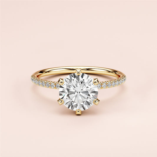 Elegant 14K yellow gold engagement ring with a round cut diamond center and pave diamond band, perfect for special occasions.