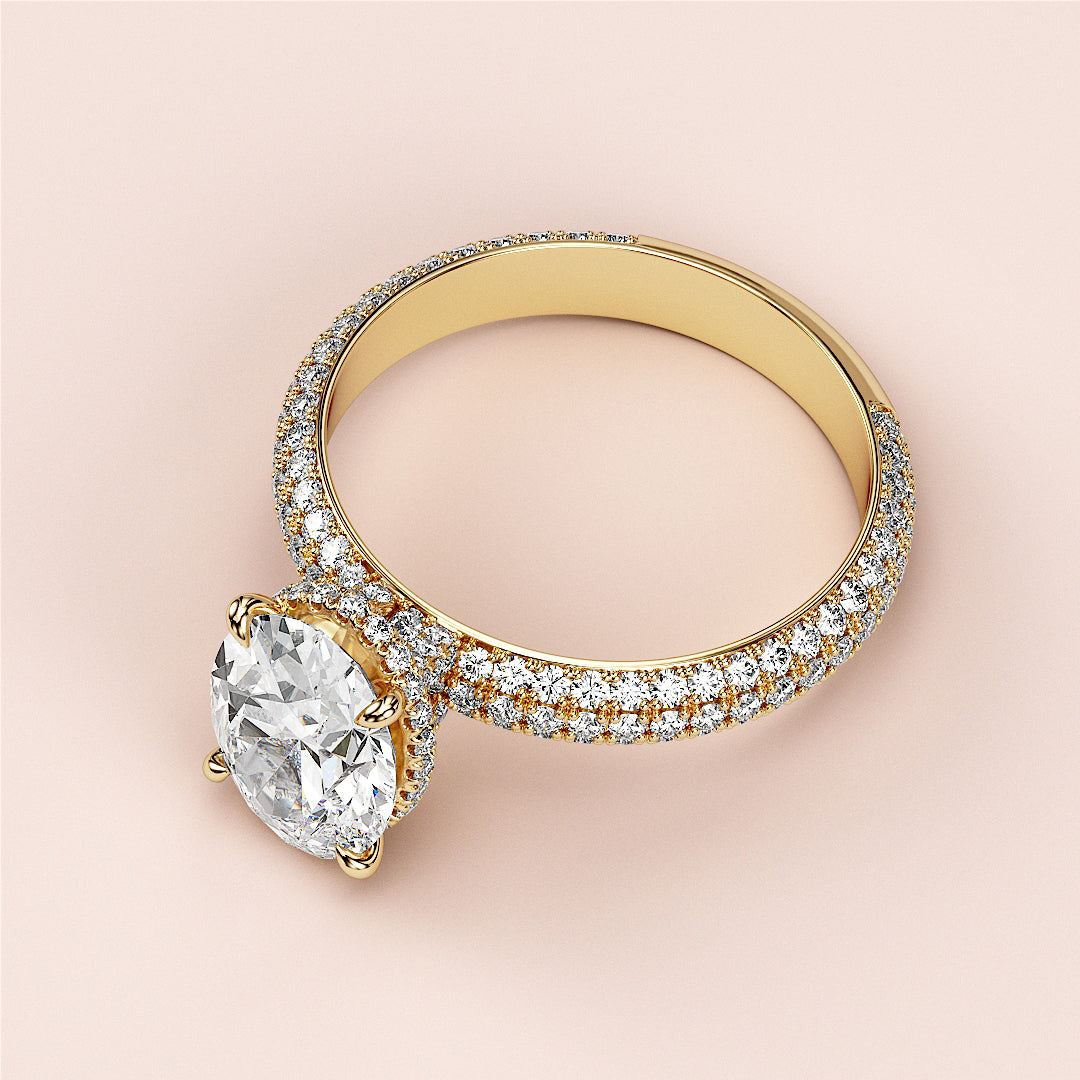 Elegant 14K yellow gold engagement ring featuring an oval hidden halo andPave accents, showcasing a stunning round diamond.|
#14KRecycledYellowGold
#18KRecycledYellowGold