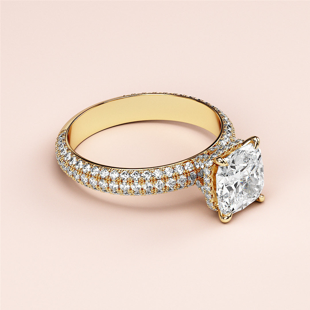 Elegant engagement ring with a cushion-cut diamond in 14K yellow gold, featuring hidden halo and pave accents.|
#14KRecycledYellowGold
#18KRecycledYellowGold