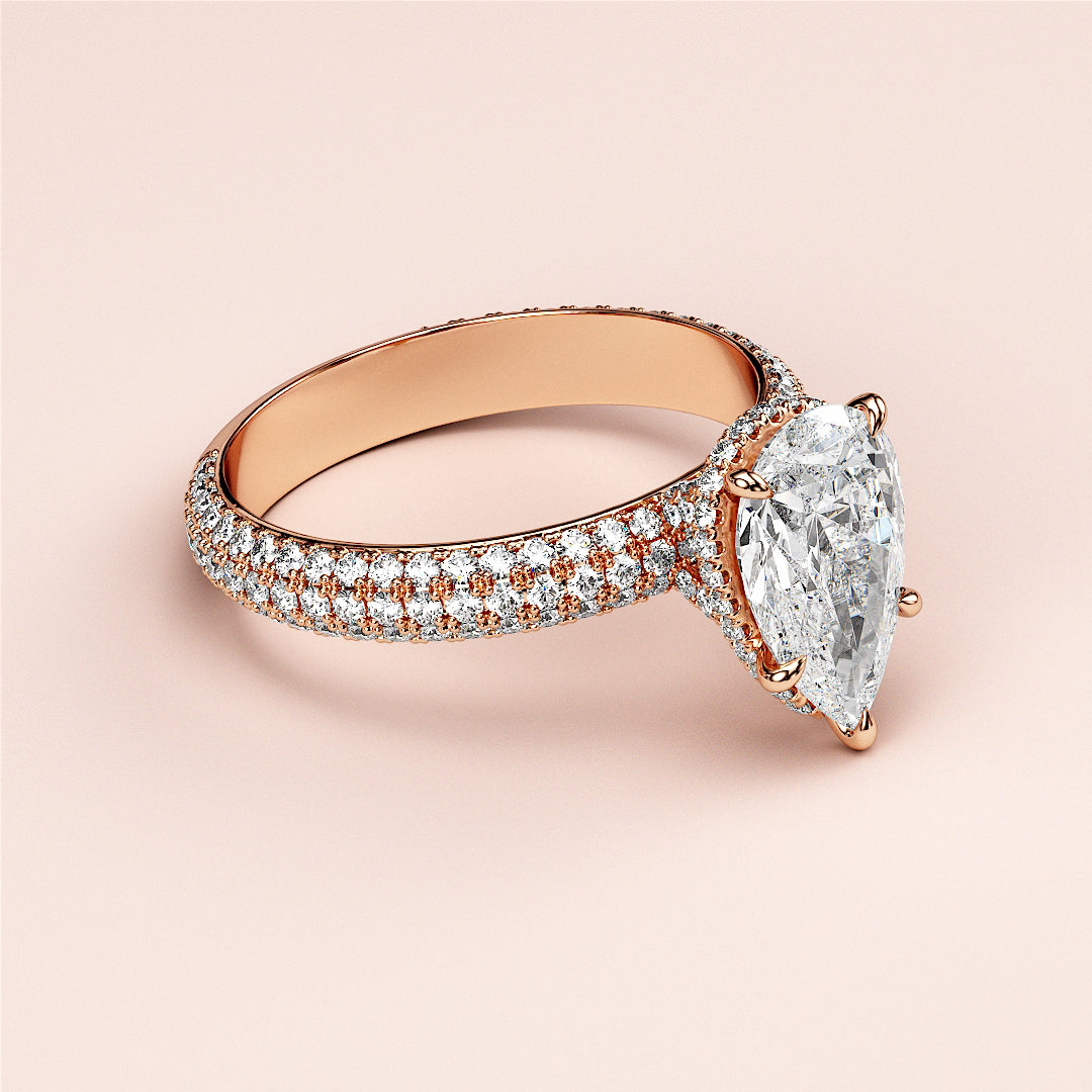 Elegant 14K or 18K rose gold engagement ring featuring a pear-shaped diamond withPave accents, perfect for a timeless proposal.|
#14KRecycledRoseGold
#18KRecycledRoseGold