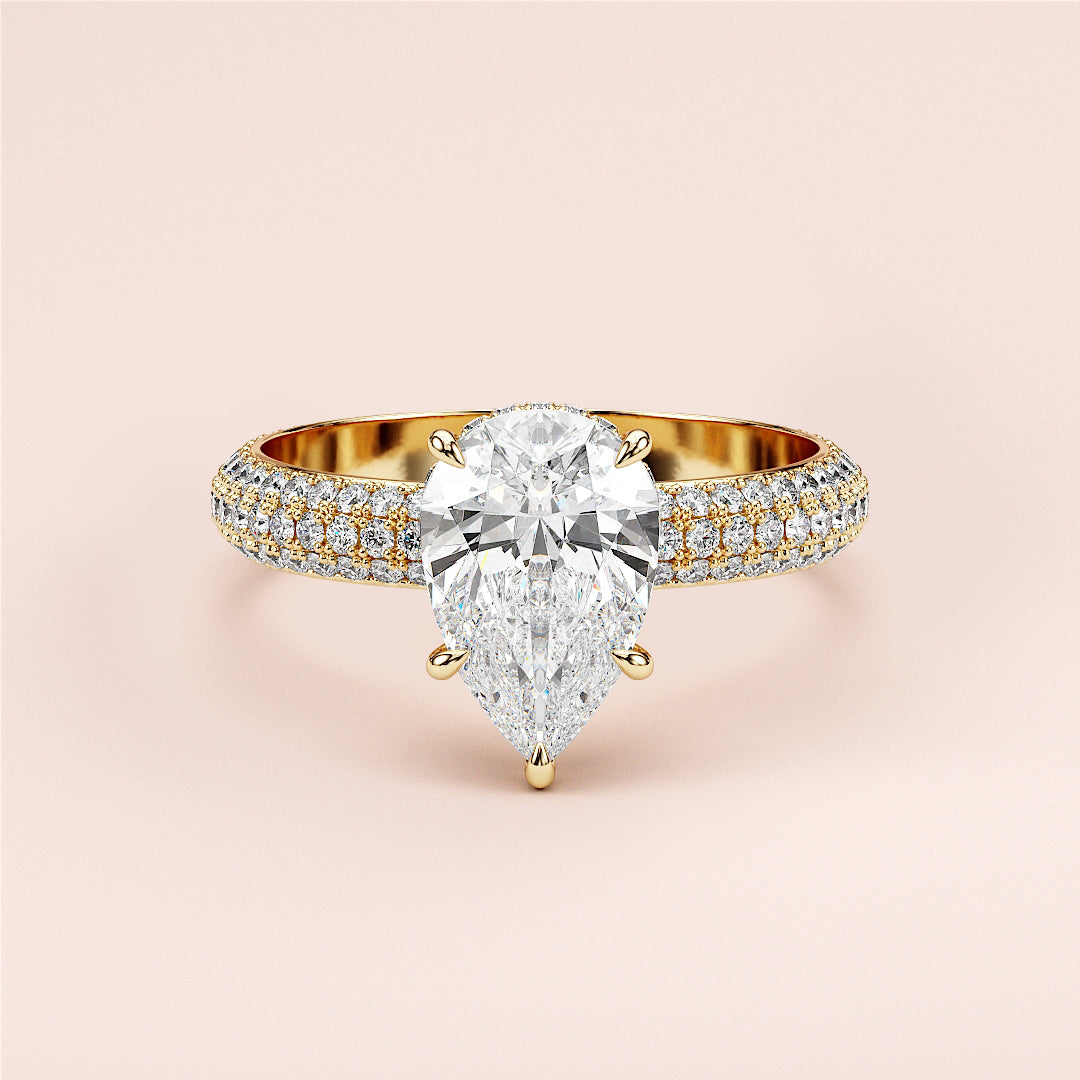 Elegant pear-shaped diamond engagement ring in 14K or 18K gold or platinum, featuringPave accents on the band. Unworn against neutral backdrop.|
#14KRecycledYellowGold
#18KRecycledYellowGold