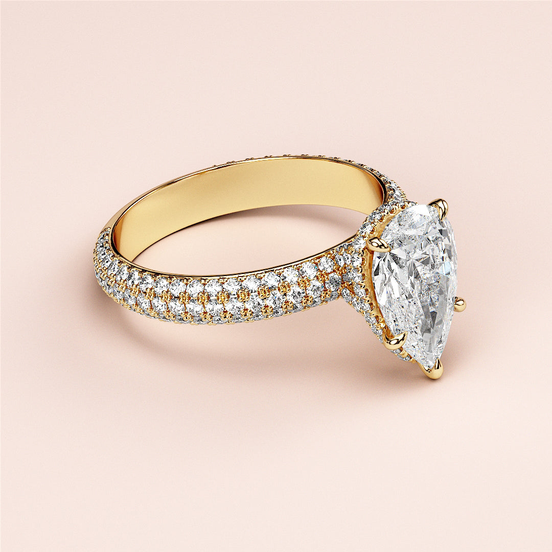 Elegant pear-shaped diamond ring in 14K or 18K gold with hidden halo accents and intricate pave band design.|
#14KRecycledYellowGold
#18KRecycledYellowGold