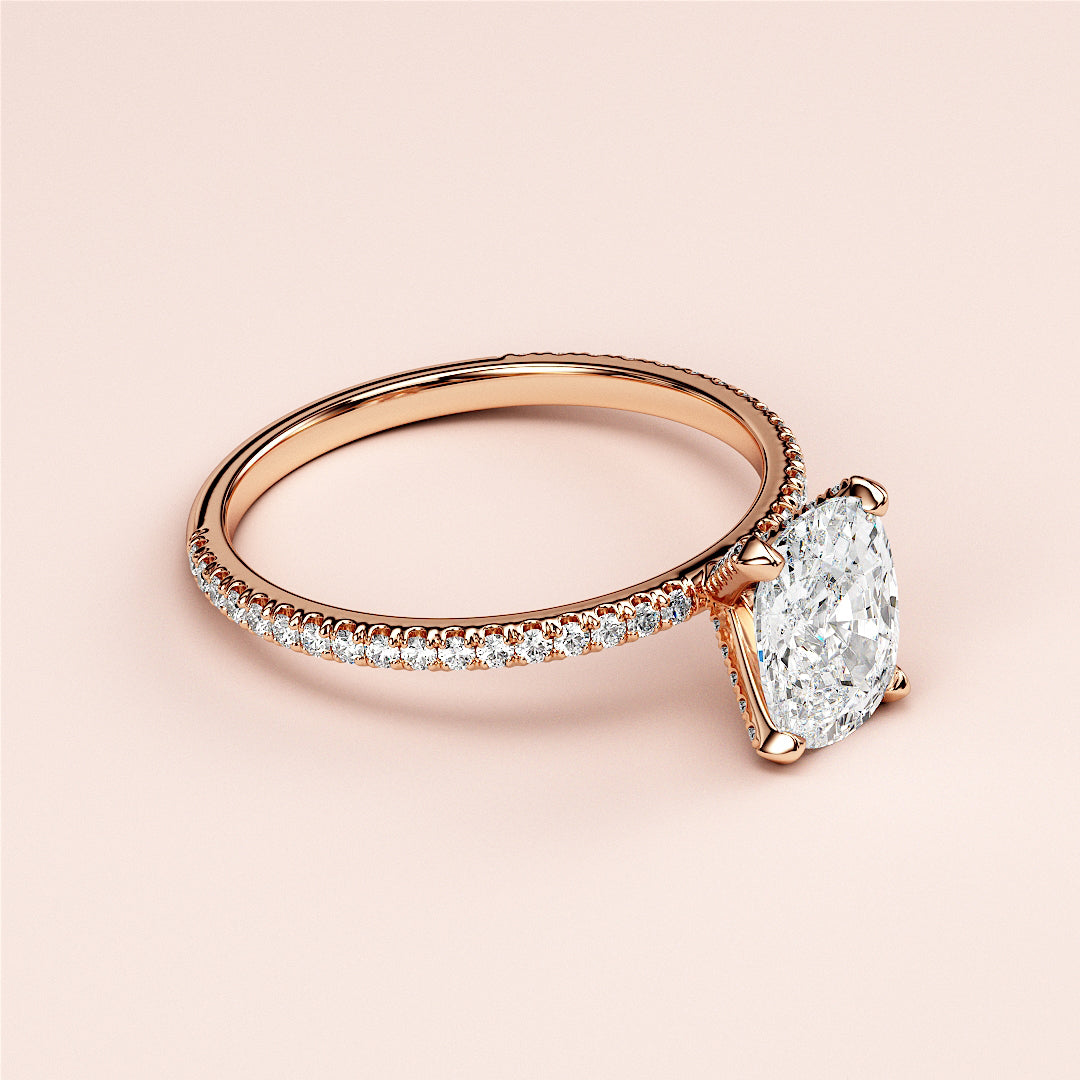 Rose gold engagement ring with a large oval diamond, featuring small round diamonds, available in 14K, 18K, or platinum.|
#14KRecycledRoseGold
#18KRecycledRoseGold