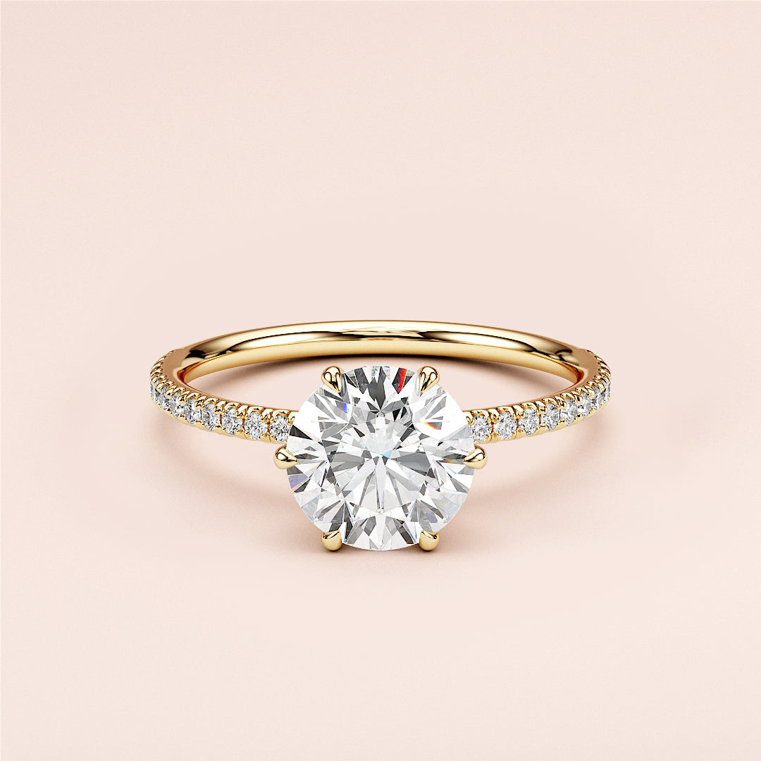 Elegant 14K or 18K yellow gold engagement ring featuring a round-cut diamond in a halo setting with a pave band.|
#14KRecycledYellowGold
#18KRecycledYellowGold