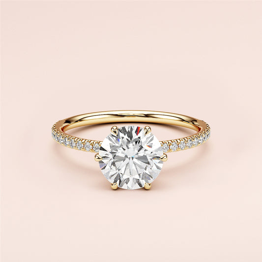 Elegant 14K or 18K yellow gold engagement ring featuring a round-cut diamond in a halo setting with a pave band.