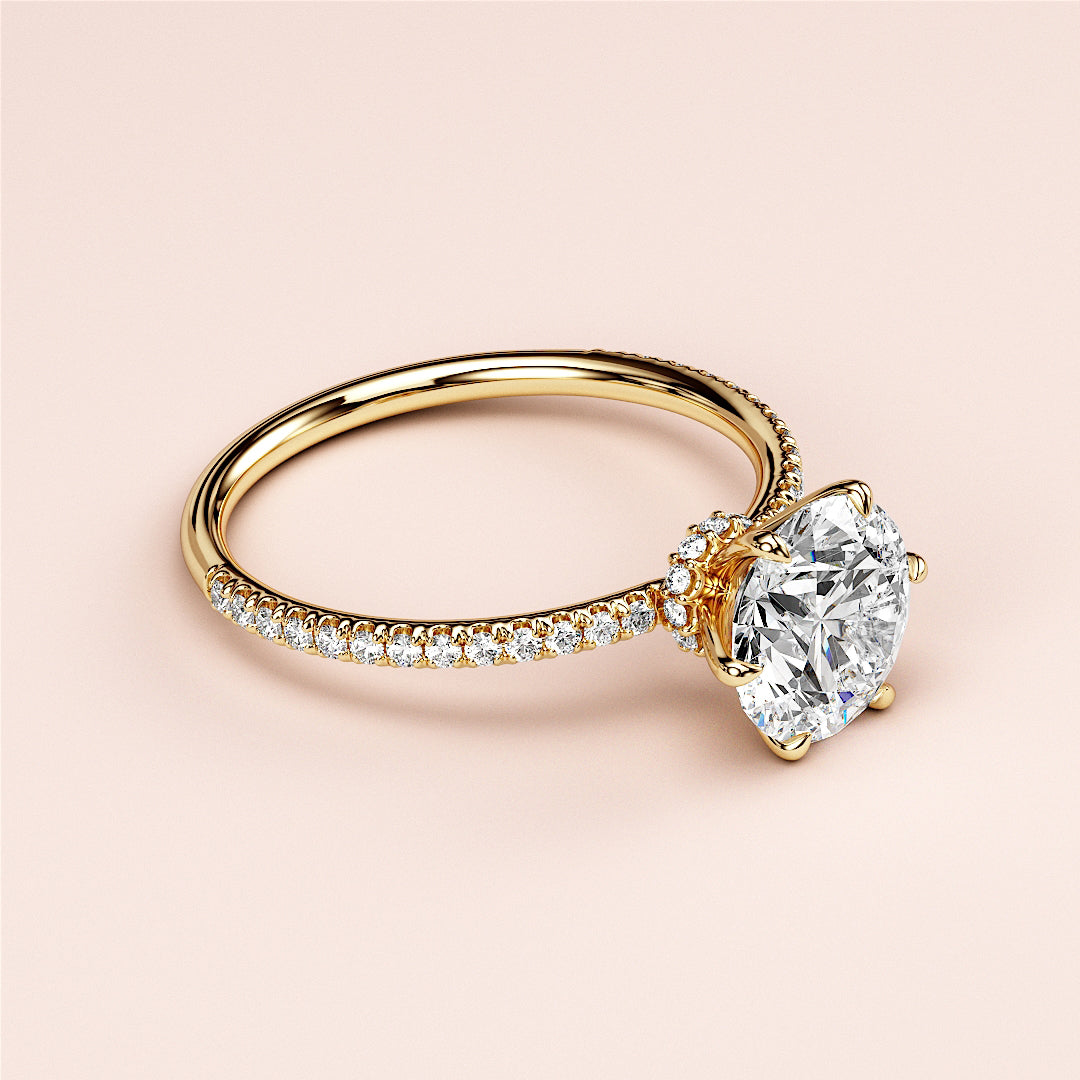 Elegant 14K yellow gold engagement ring featuring a round brilliant-cut diamond, accented by smaller diamonds on a delicate band.|
#14KRecycledYellowGold
#18KRecycledYellowGold