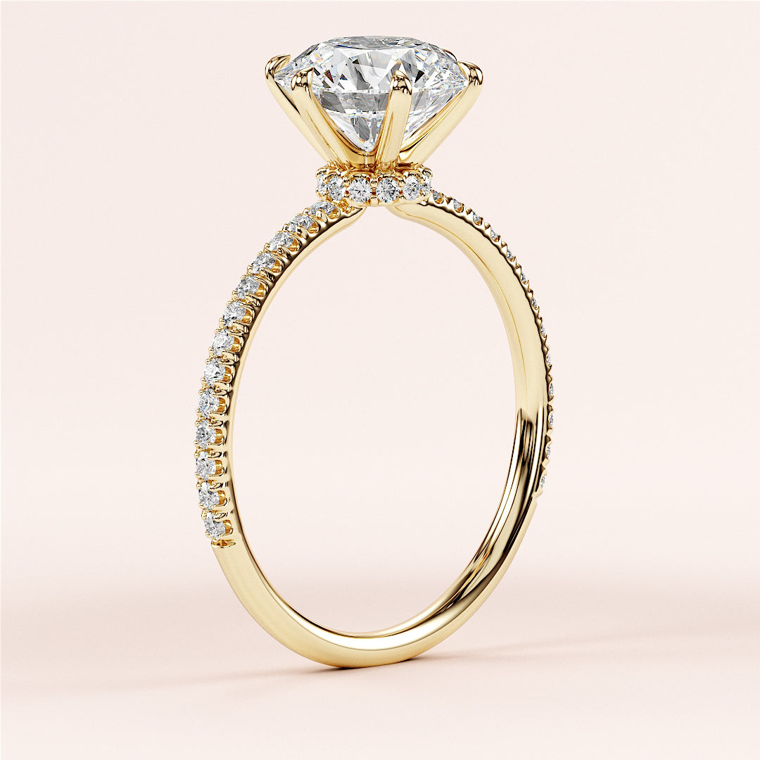 Close-up of a stunning 14K and 18K yellow gold diamond engagement ring with a round halo, prong setting, and pave band.|
#14KRecycledYellowGold
#18KRecycledYellowGold