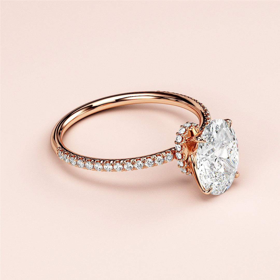 Exquisite 14K rose gold oval solitaire halo engagement ring with diamond accents, perfect for a timeless proposal.|
#14KRecycledRoseGold
#18KRecycledRoseGold