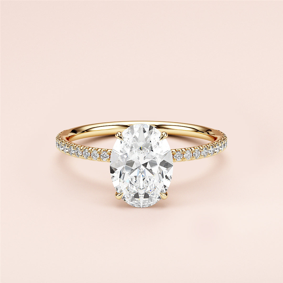 Elegant yellow gold 14K or 18KPave band oval diamond engagement ring, showcasing a stunning center stone, worn on a model.|
#14KRecycledYellowGold
#18KRecycledYellowGold