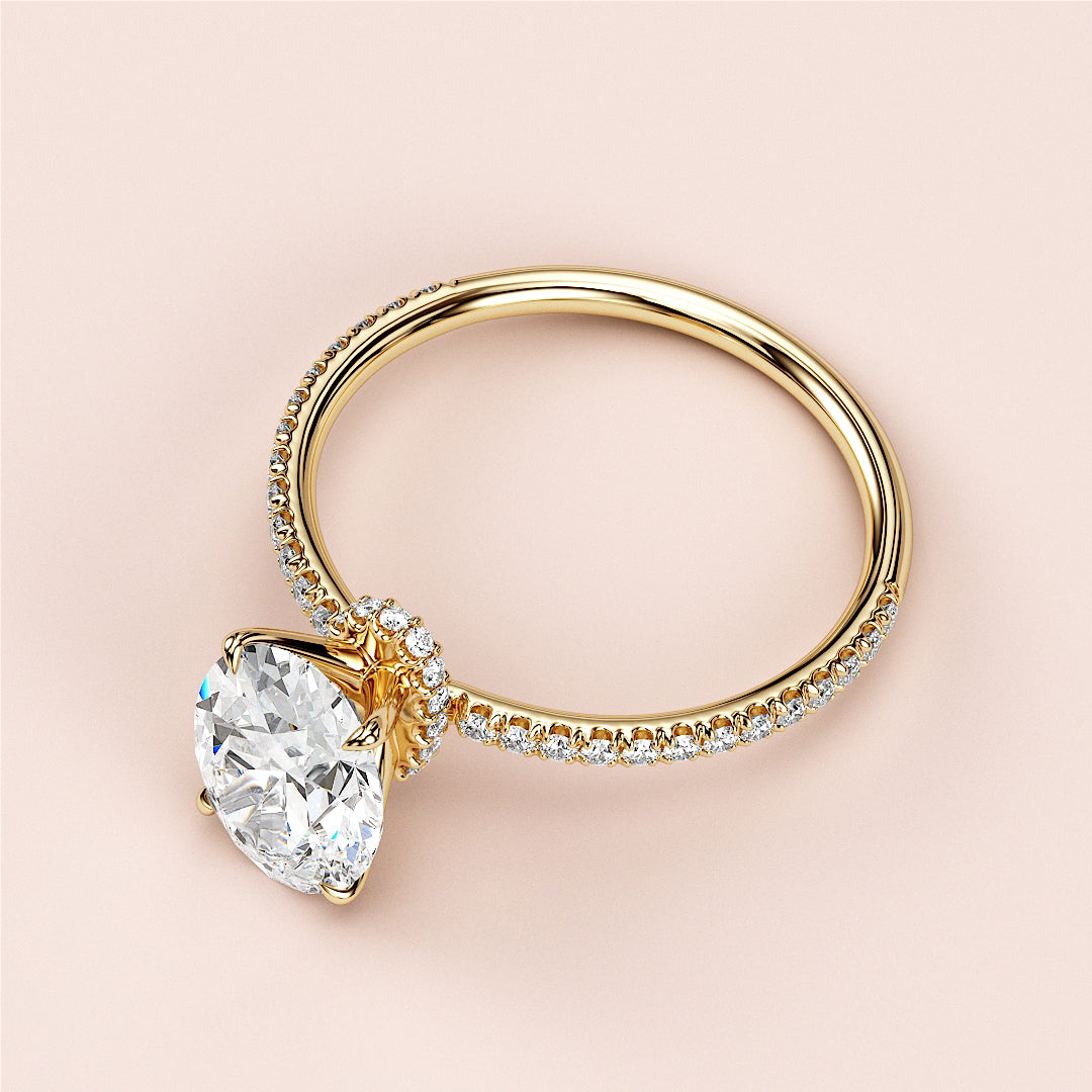 Luxurious 14K yellow gold engagement ring with pear-shaped diamond halo and encrusted band, not worn on a model.|
#14KRecycledYellowGold
#18KRecycledYellowGold