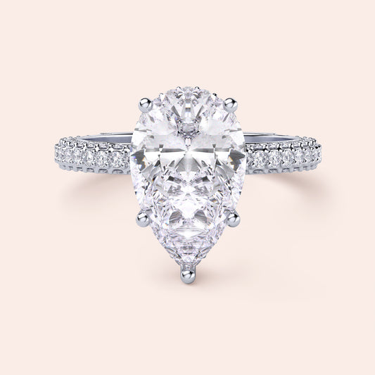 Elegant pear-shaped diamond engagement ring in 14K/18K gold or platinum, featuring a sparkling diamond-studded band.