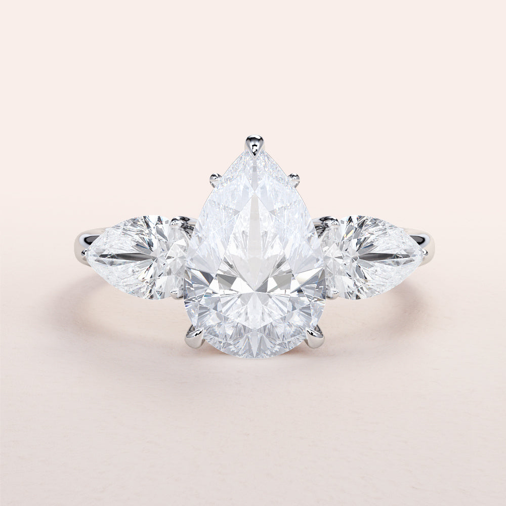 Pear-shaped diamond engagement ring in 14K white gold, featuring a center stone and two pear-shaped side stones for a stunning look.|
#14KRecycledWhiteGold
#18KRecycledWhiteGold
#Platinum