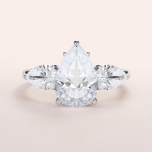 Pear-shaped diamond engagement ring in 14K white gold, featuring a center stone and two pear-shaped side stones for a stunning look.