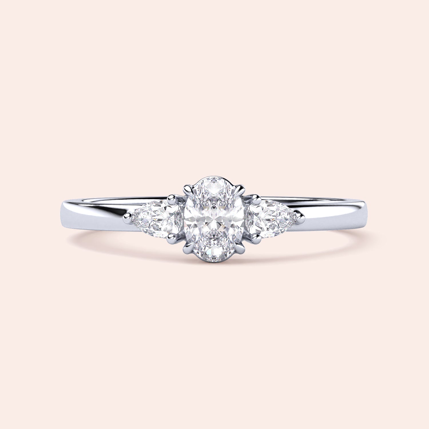 Elegant 14K white gold engagement ring featuring an oval diamond center and two pear-shaped side stones in a three-stone setting.|
#14KRecycledWhiteGold
#18KRecycledWhiteGold
#Platinum