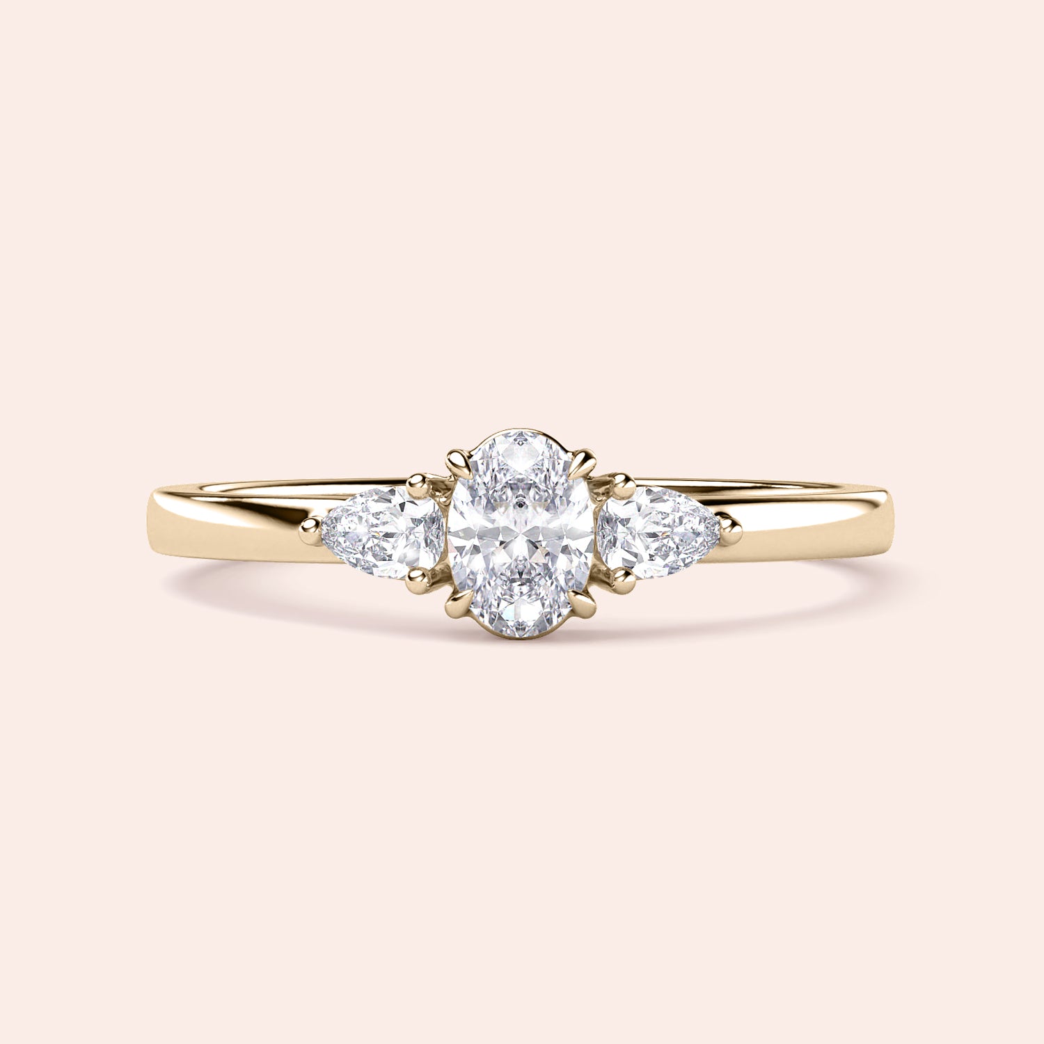 Elegant 14K or 18K gold or platinum engagement ring featuring an oval diamond and pear-shaped side stones, ideal for special occasions.|
#14KRecycledYellowGold
#18KRecycledYellowGold