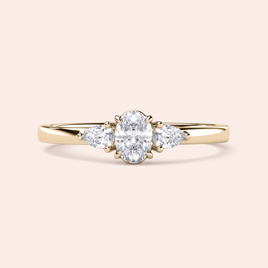 Elegant 14K or 18K gold or platinum engagement ring featuring an oval diamond and pear-shaped side stones, ideal for special occasions.