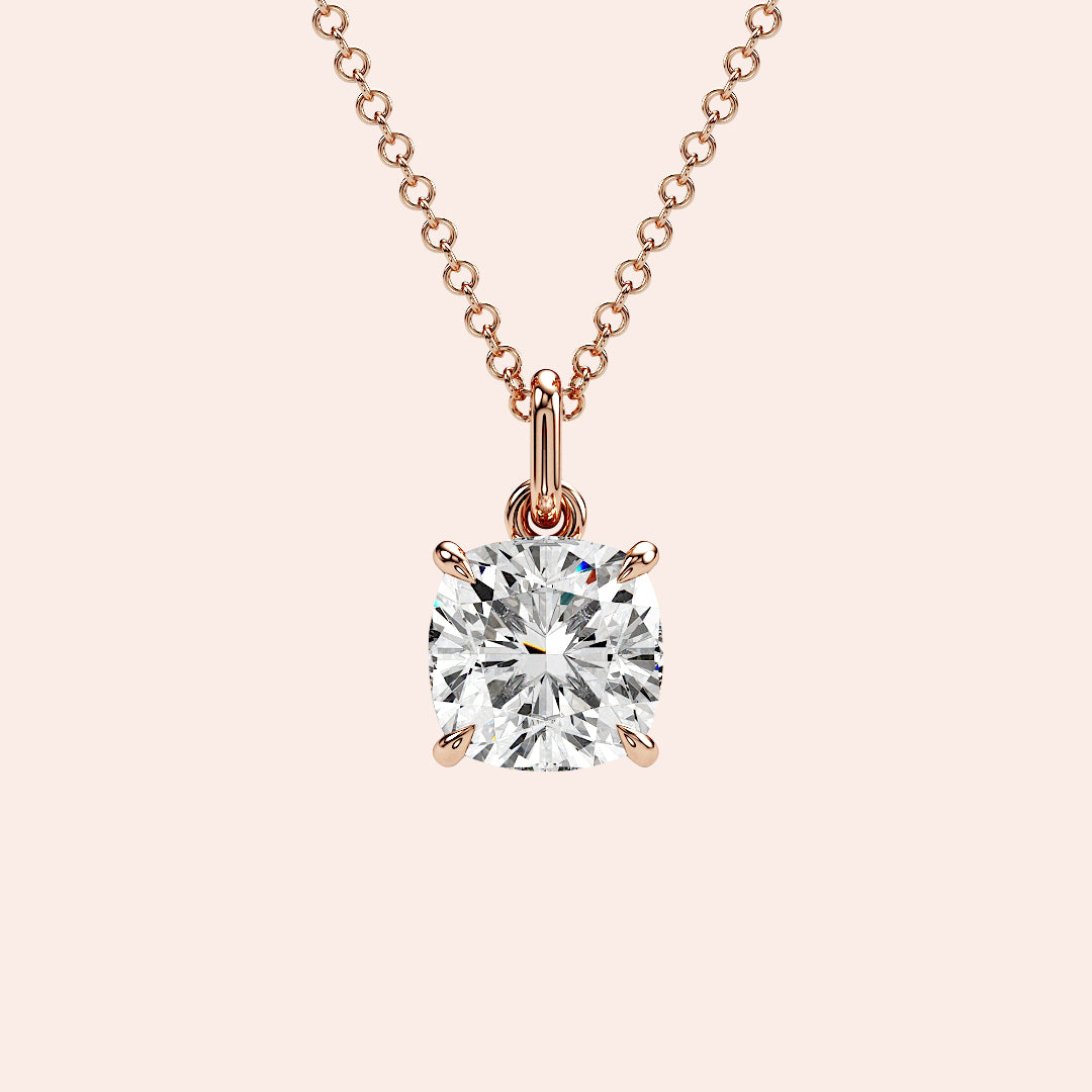 A detailed close-up of a cushion-cut solitaire diamond pendant set in a four-prong rose gold basket. The refined craftsmanship highlights the brilliance of the diamond, making it a must-have piece for any fine jewelry collection.| #14KRecycledRoseGold #18KRecycledRoseGold