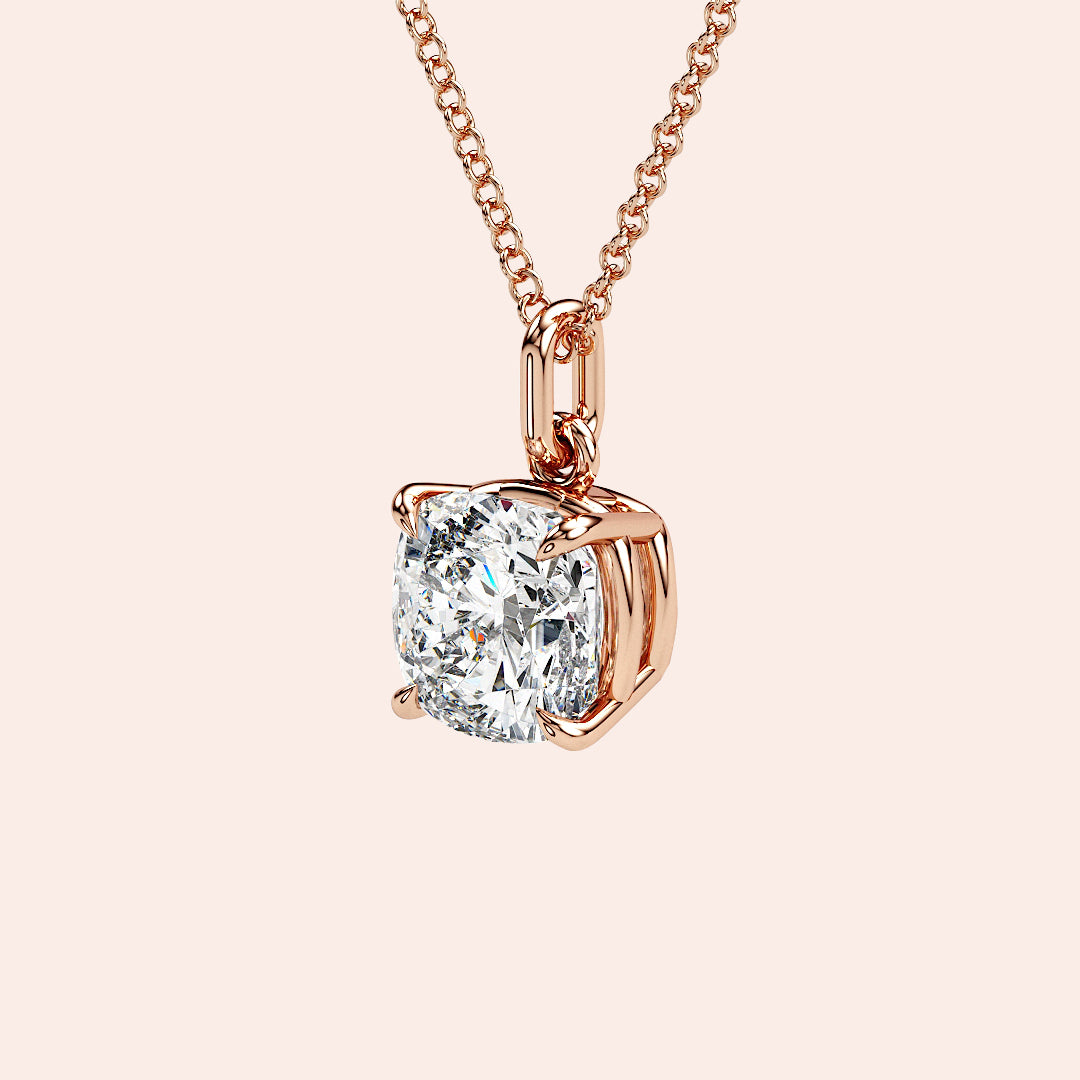 A front-facing view of a cushion-cut solitaire diamond pendant set in a delicate four-prong rose gold setting. This classic and elegant design enhances the diamond’s brilliance, making it an iconic jewelry staple for any occasion.| #14KRecycledRoseGold #18KRecycledRoseGold